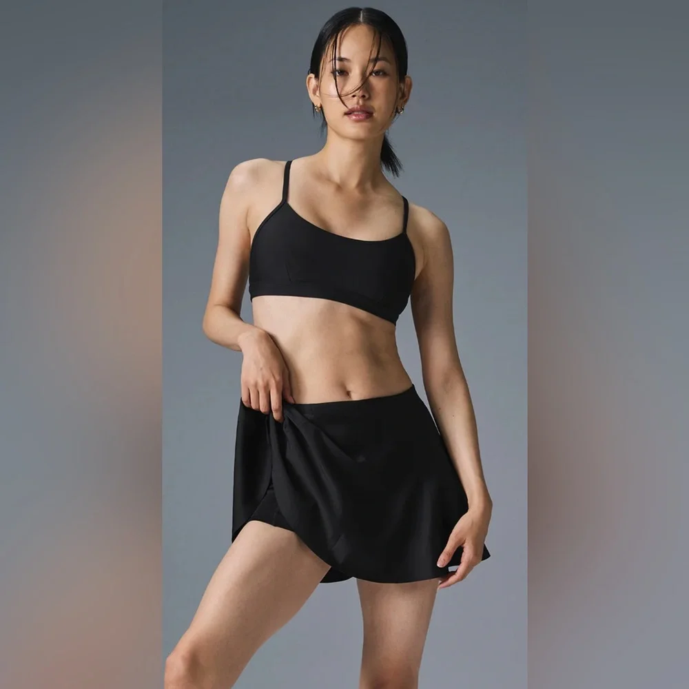 ALO Yoga Airlight Down The Line Black Mini Tennis Skirt with shorts underneath